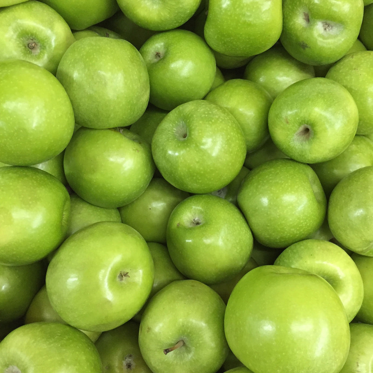 Close-up of a pile of fresh green apples