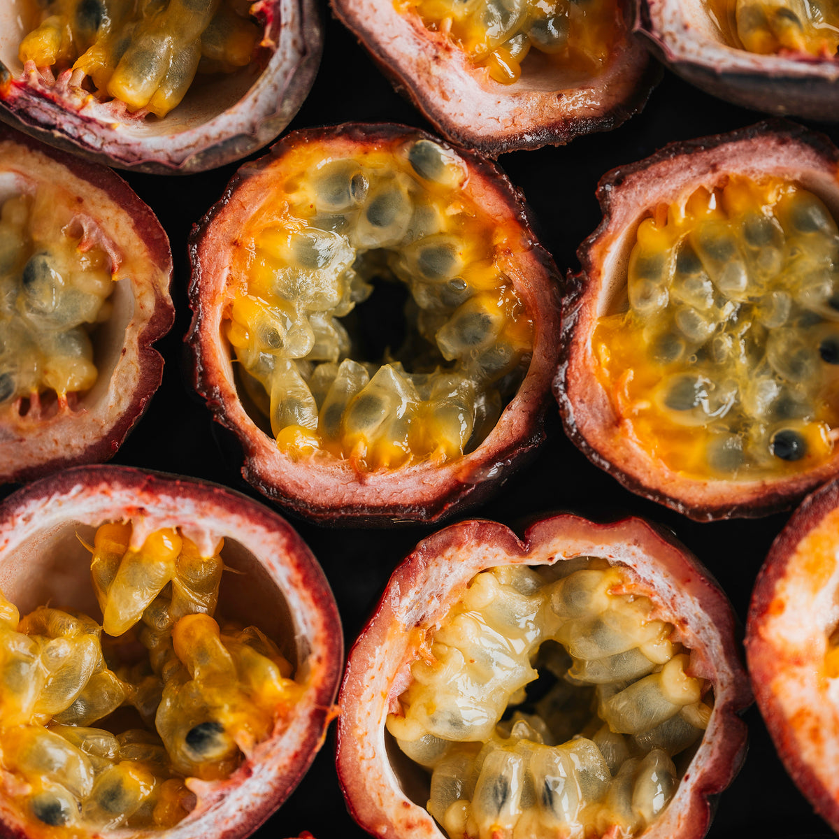 Halved passionfruit showing yellow pulp and seeds, viewed from above